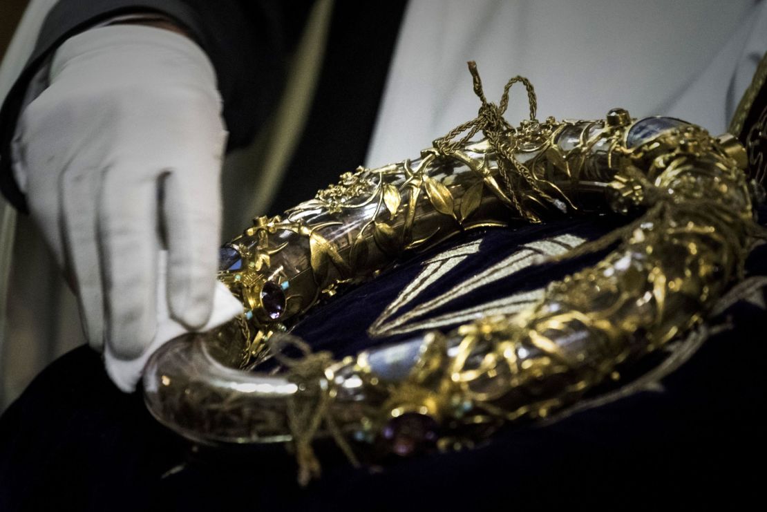 A priest wipes the Crown of Thorns, a relic of the passion of Christ at the Notre-Dame Cathedral in Paris on April 14, 2017.