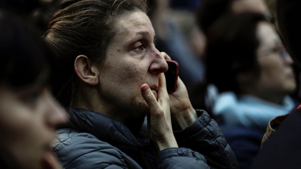 A woman reacts as she watches the flames engulf the roof of the  Notre-Dame Cathedral in Paris on April 15, 2019. - A huge fire swept through the roof of the famed Notre-Dame Cathedral in central Paris on April 15, 2019, sending flames and huge clouds of grey smoke billowing into the sky. The flames and smoke plumed from the spire and roof of the gothic cathedral, visited by millions of people a year. A spokesman for the cathedral told AFP that the wooden structure supporting the roof was being gutted by the blaze. (Photo by Geoffroy VAN DER HASSELT / AFP)        (Photo credit should read GEOFFROY VAN DER HASSELT/AFP/Getty Images)