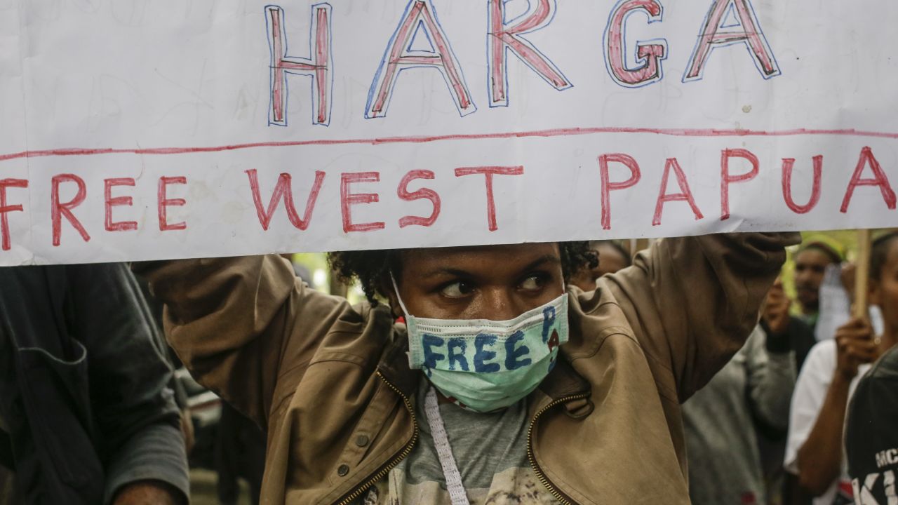 A West Papuan activist holds a banner demanding independence. 
