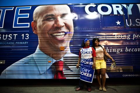 Women pose next to Booker's campaign bus during a rally in Newark in August 2013. Booker was running for the US Senate seat that was vacated when five-term incumbent Frank Lautenberg died at the age of 89.
