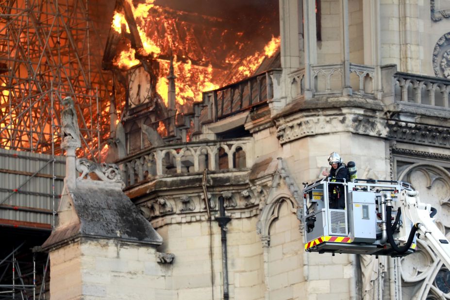 A firefighter gets closer to the flames.