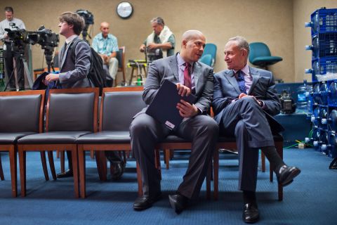 Booker talks with US Sen. Chuck Schumer after a news conference about Iran in October 2015.