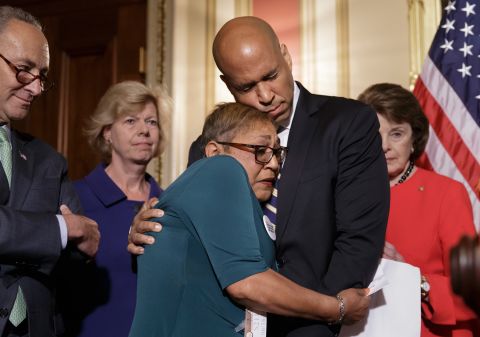 During a news conference in June 2016, Booker embraces the Rev. Sharon Risher, a clinical trauma chaplain who lost her mother and two cousins in a church shooting in Charleston, South Carolina. Democratic senators were calling for gun-control legislation after a mass shooting at an Orlando nightclub.
