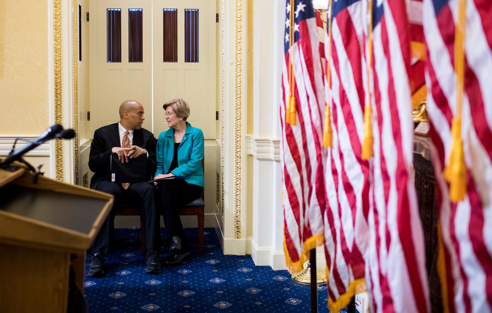 Booker and US Sen. Elizabeth Warren talk before the start of a July 2017 news conference that introduced the Dignity for Incarcerated Women Act.