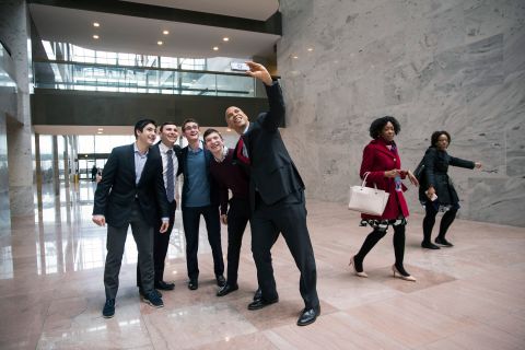 Booker poses for a photo with a group of visitors at the Hart Senate Office Building in Washington in January 2019.
