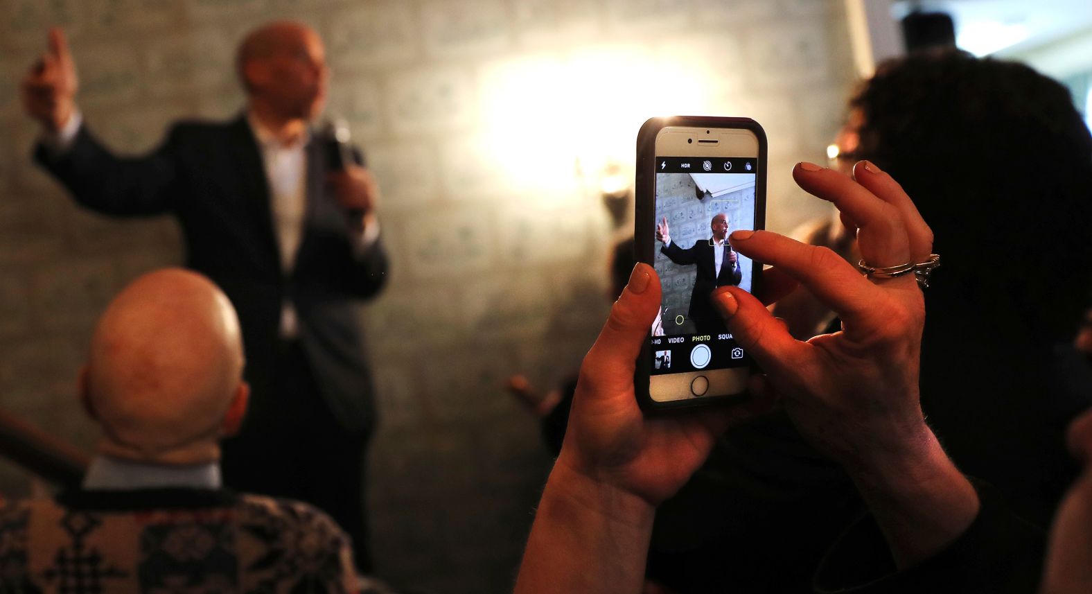 Someone takes a photo of Booker during a campaign stop in Claremont, New Hampshire, in March 2019.
