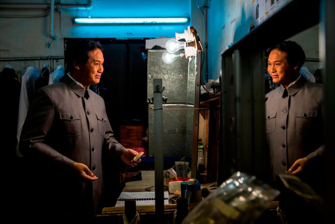 Loong Koon-tin, who also plays former Chinese leader Mao Zedong, prepares backstage during a rehearsal.