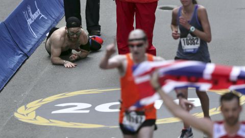 Micah Herndon crawls to the finish line in the 123rd Boston Marathon.