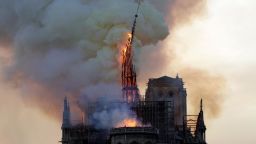 The steeple of the landmark Notre-Dame Cathedral collapses as the cathedral is engulfed in flames in central Paris on April 15, 2019. - A huge fire swept through the roof of the famed Notre-Dame Cathedral in central Paris on April 15, 2019, sending flames and huge clouds of grey smoke billowing into the sky. The flames and smoke plumed from the spire and roof of the gothic cathedral, visited by millions of people a year. A spokesman for the cathedral told AFP that the wooden structure supporting the roof was being gutted by the blaze. (Photo by Geoffroy VAN DER HASSELT / AFP)        (Photo credit should read GEOFFROY VAN DER HASSELT/AFP/Getty Images)