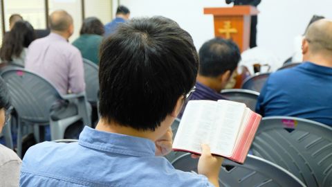 A Chinese Christian reads a Bible at a church in Nairobi.