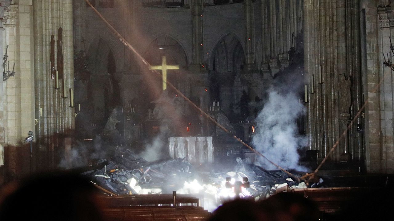 Smoke rises in front of the altar at Notre Dame cathedral after fire engulfed the building.