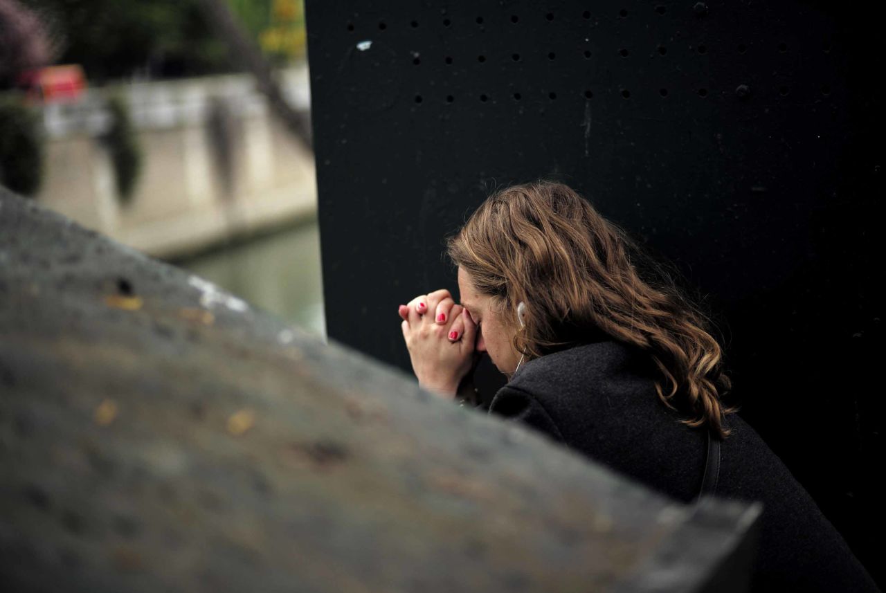A woman reacts near Notre Dame the morning after the devastating fire.