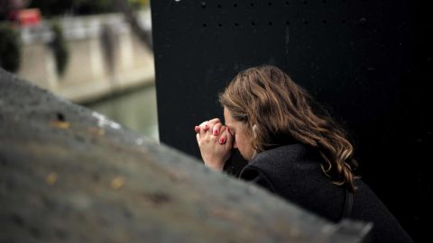 A woman reacts near Notre Dame the morning after the devastating fire.