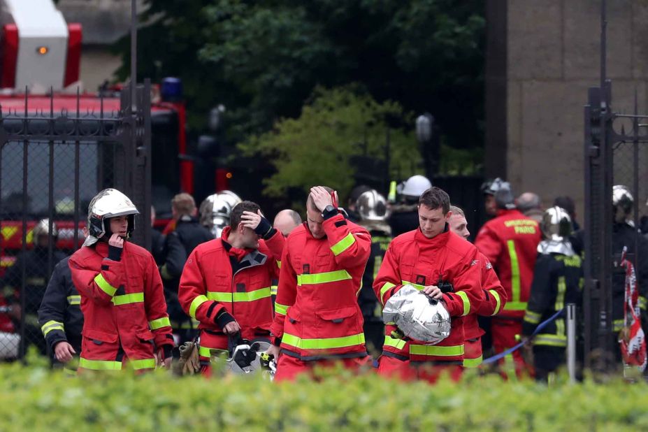 Firefighters exit Notre Dame Cathedral on April 16, 2019.