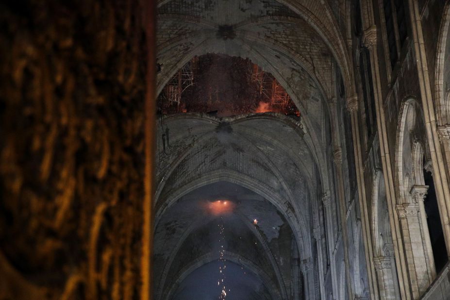The interior of the cathedral roof is seen smoldering.