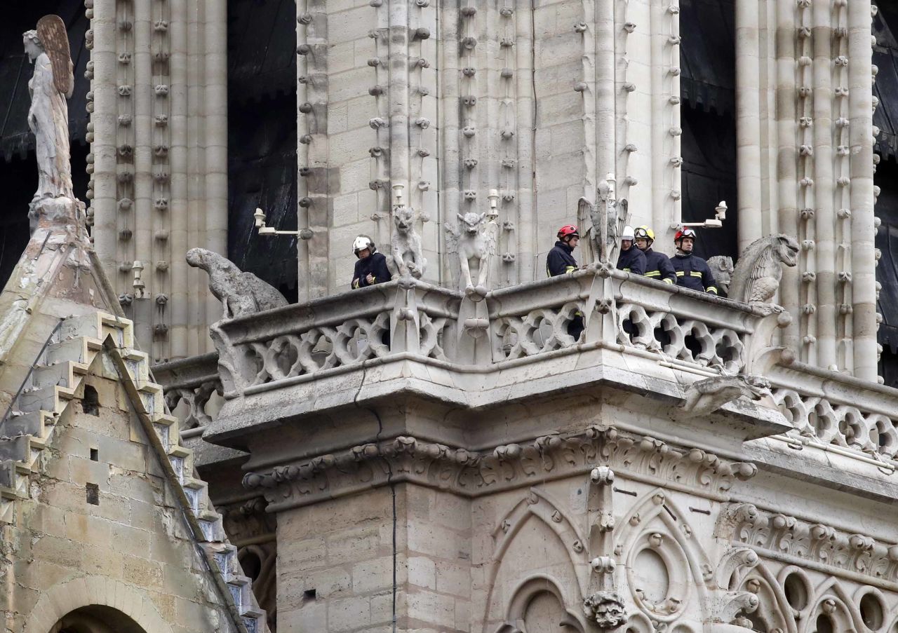 Members of the fire department inspect the cathedral.