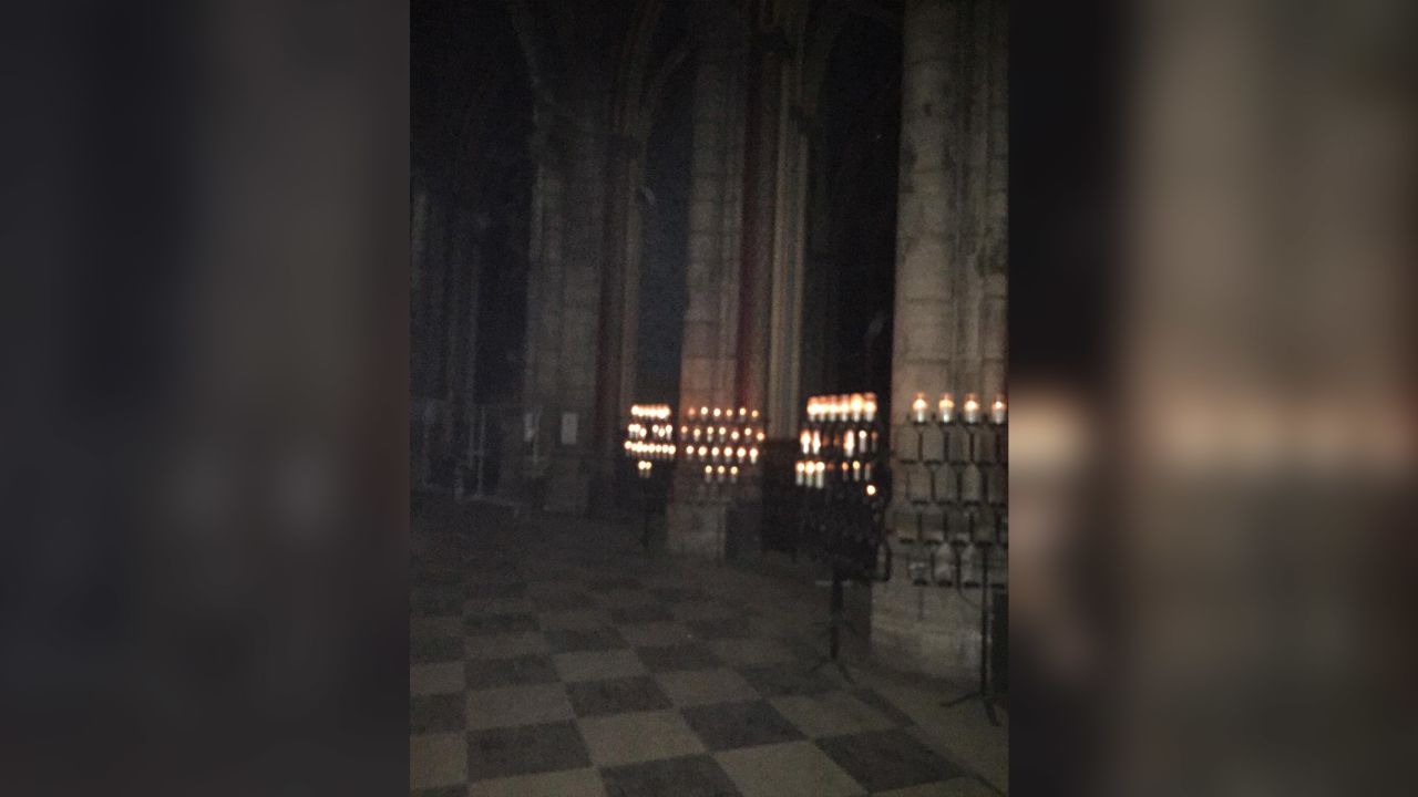 Candles still burning inside the cathedral overnight in this photo obtained by CNN.
