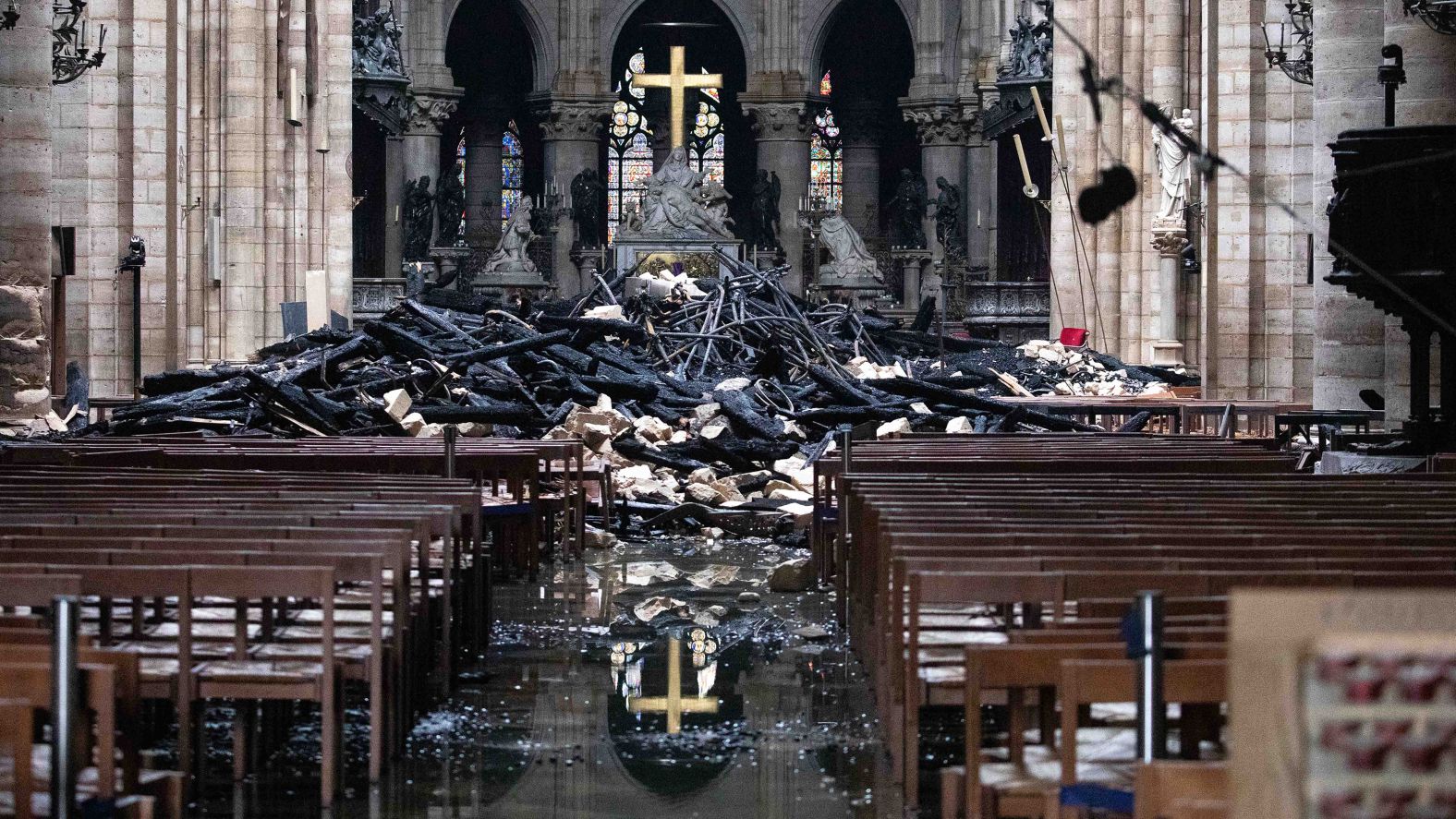 Debris from the roof lies near the altar inside Notre Dame Cathedral in Paris on April 16, 2019, the day after the devastating fire.