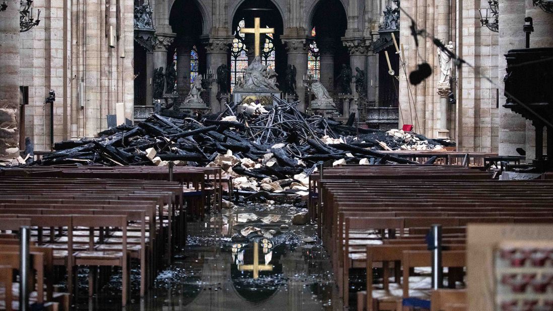 Debris from the roof lies near the altar inside Notre Dame Cathedral in Paris on April 16, 2019, the day after the devastating fire.