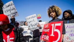 Detroit resident Betty Killingsworth, right, stands tall with a few dozen cooks and cashiers marching throughout the parking lot on Wednesday, April 3, 2019, during a rally at McDonald's in the 1500 block of W. Stewart Avenue in Flint, demanding a $15 hourly minimum wage increase, union rights and calling on the company not to just stop lobbying against them, but join in the request for a higher minimum wage. Protestors gathered at 10 total locations around the nation, including Chicago, Los Angeles and Memphis, among others. (Jake May/The Flint Journal via AP)