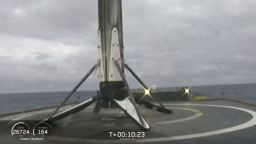 This Thursday, April 11, 2091 image from video made available by SpaceX shows a Falcon rocket booster shortly after landing on a barge in the Atlantic Ocean off Florida. On Tuesday, April 16, the company confirmed that the unsecured core booster toppled onto the platform over the weekend, as waves reached 8 to 10 feet. SpaceX chief Elon Musk says custom devices to secure the booster weren't ready in time for this second flight of the Falcon Heavy. (SpaceX via AP)