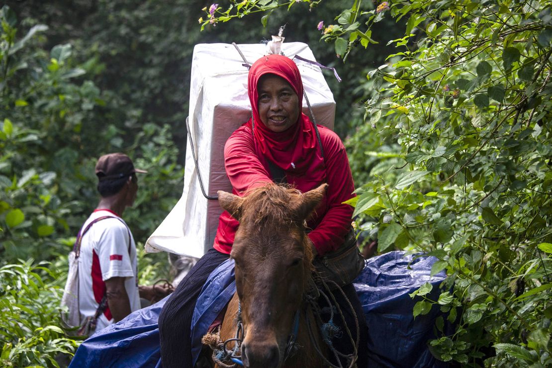 An Indonesian election worker on horseback transports ballot boxes and election material to a remote village in Jember, East Java on April 15, 2019. 