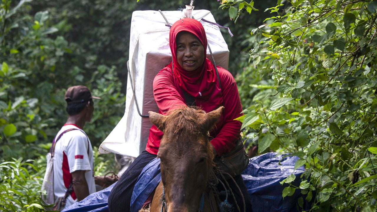 An Indonesian election worker on horseback transports ballot boxes and election material to a remote village in Jember, East Java on April 15, 2019.