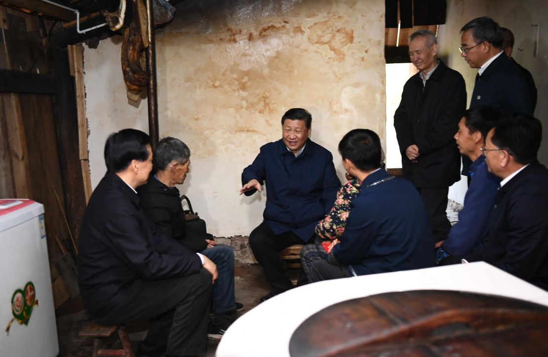 Chinese President Xi Jinping visits a villager's home to learn about the progress of poverty alleviation in Huaxi village on April 15.