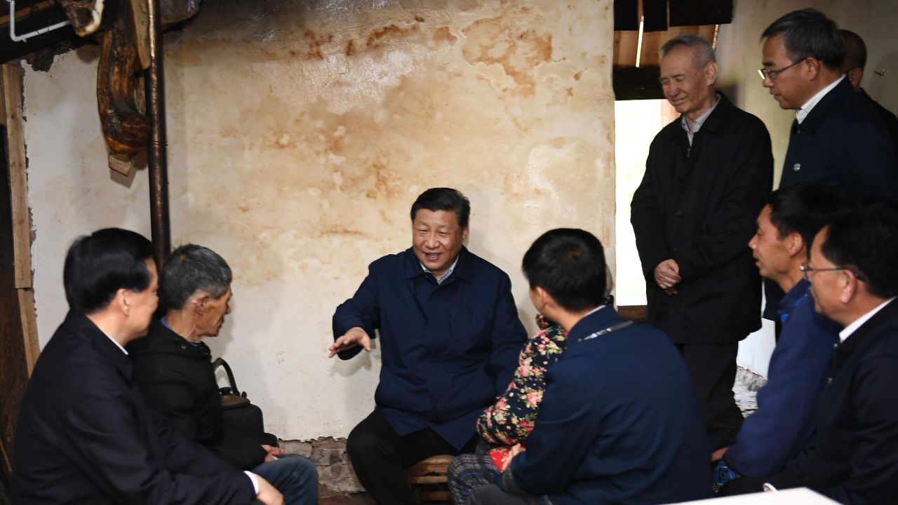 Chinese President Xi Jinping visits a villager's home to learn about the progress of poverty alleviation in Huaxi village on April 15.
