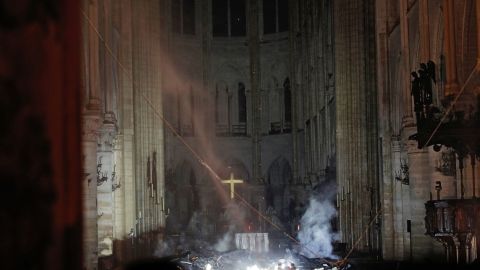 Smoke rises in front of the altar cross at Notre-Dame Cathedral in Paris on April 15, 2019, after a fire engulfed the building.