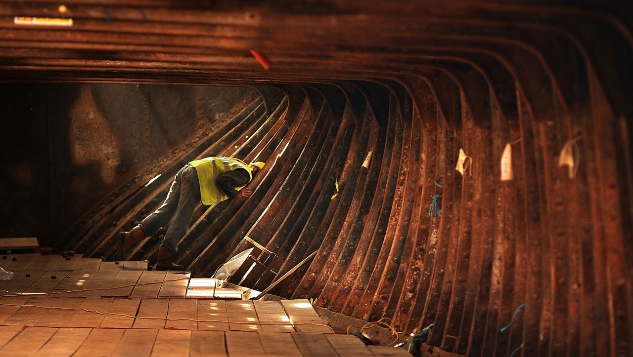 A worker inspects the hull section of The Cutty Sark on October 11, 2007. The original conservation project was interrupted because of the damage caused by a fire on March 21, 2007.