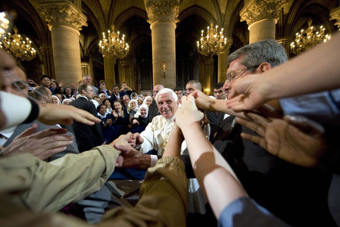 Pope Benedict XVI meets worshipers following an evening prayer service at Notre Dame Cathedral on September 12, 2008.