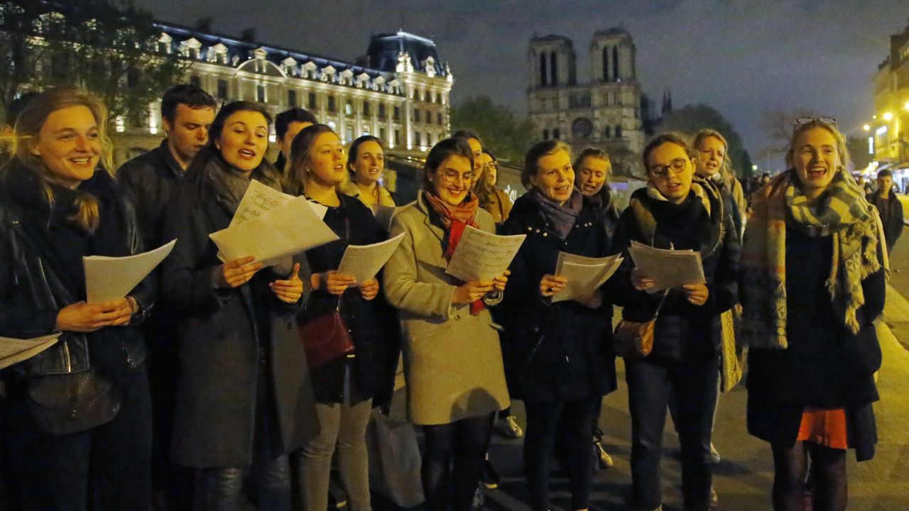 People attend a vigil near the Notre Dame cathedral in Paris on Tuesday.