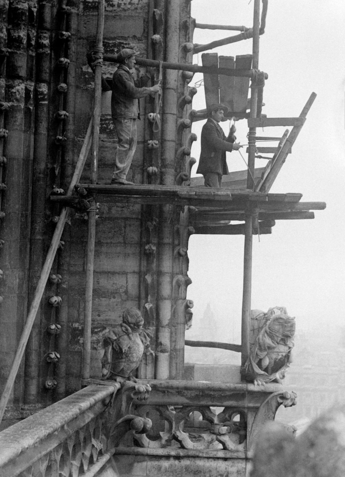 Workers carry out repair work on the cathedral in 1931.