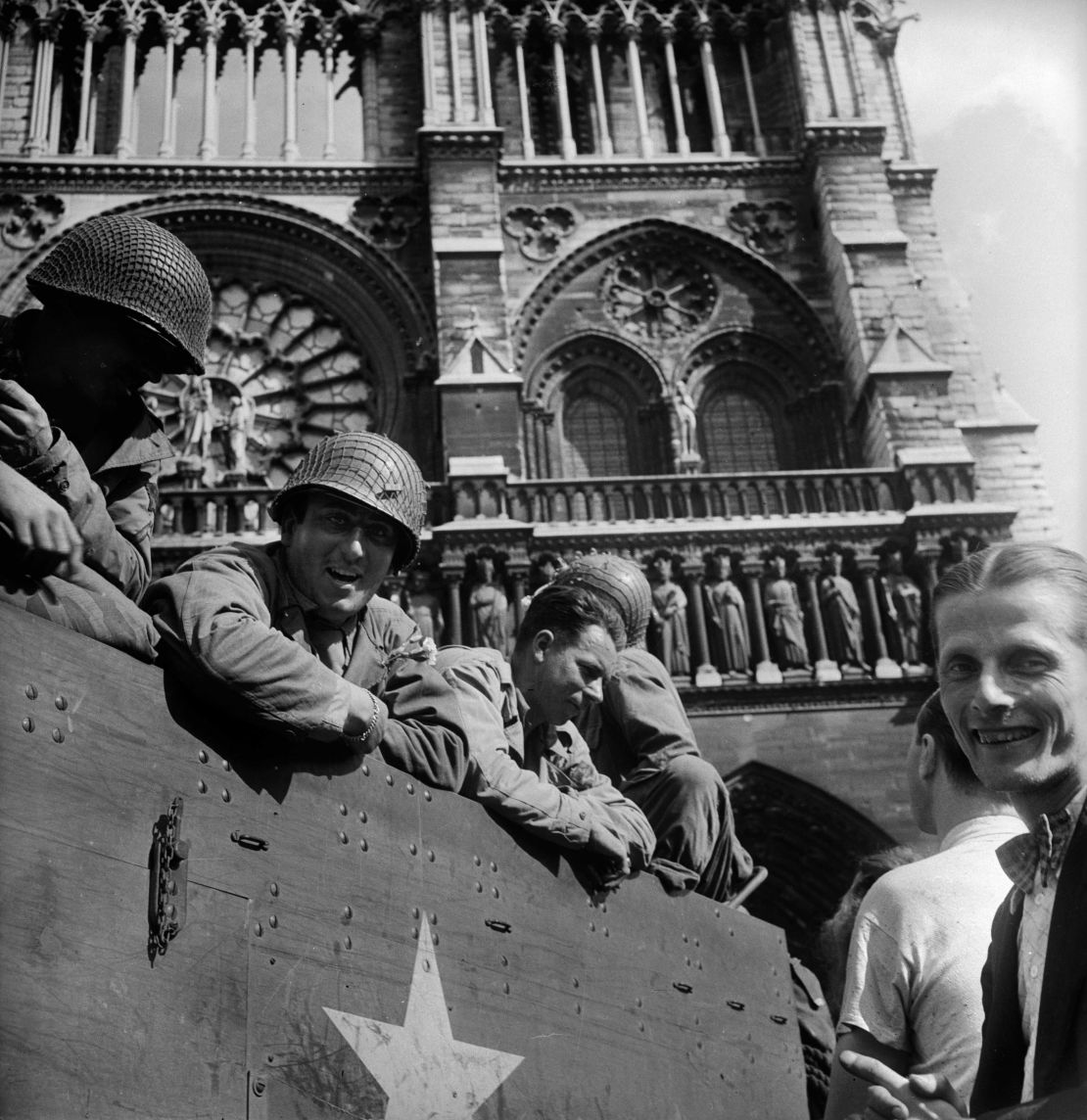 Americans soldiers celebrate the liberation of Paris in the square beside the Notre Dame Cathedral in 1944.