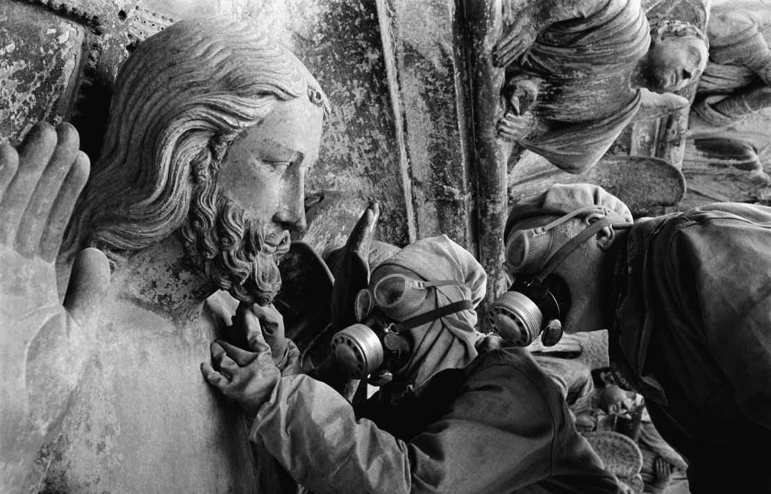 A statue on the facade of Notre Dame is cleaned by a specialist in 1963.