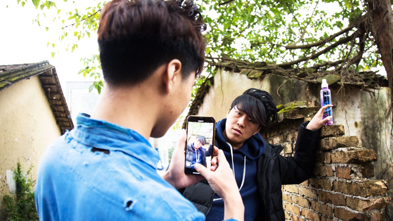 Wu Nengji shoots a scene for his video. He uses one smartphone and never does more than two takes.