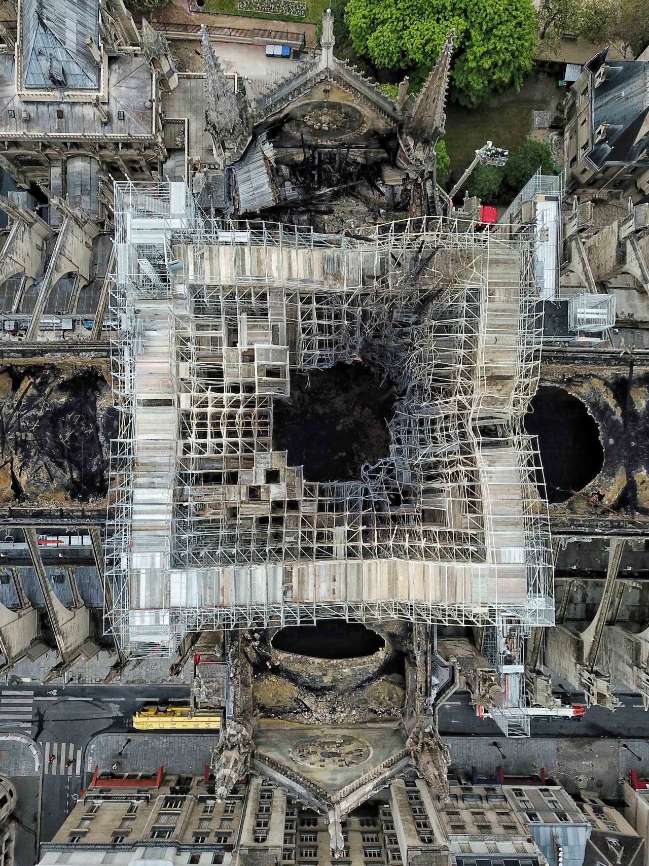 The impact of the spire's dramatic collapse is shown, with the scaffolding that held it upright twisted and tangled out of shape.