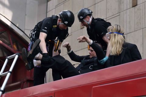 Police begin to remove climate activists who glued themselves to a train in London on April 17.