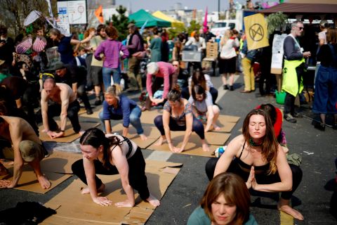 Climate change protestors practice yoga on Waterloo Bridge in central London on April 17.