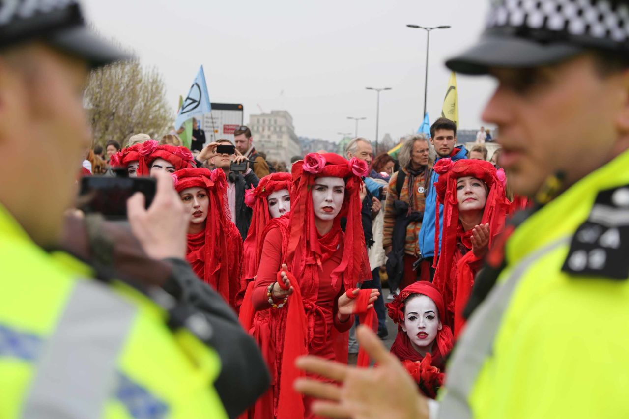 Members of the Extinction Rebellion group talk with police during a demonstration at Waterloo Bridge. 