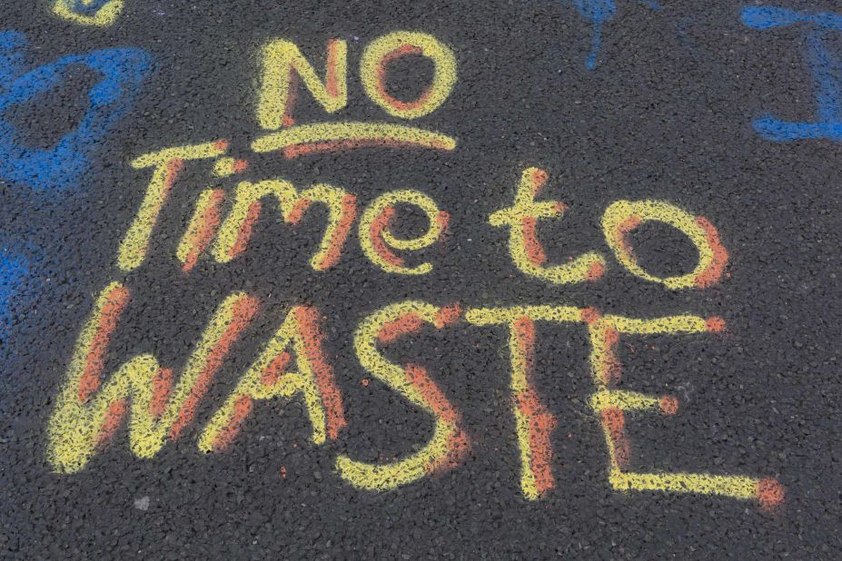 "No Time to Waste" is written on the pavement at Waterloo Bridge.