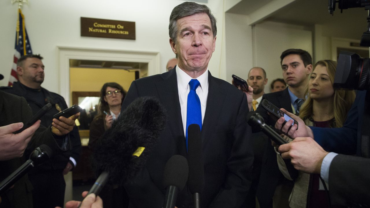 North Carolina Gov. Roy Cooper speaks with reporters after testifying before the House Natural Resources Committee hearing on climate change in Washington on February 6.