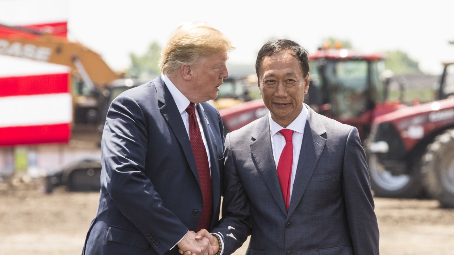 US President Donald Trump, left, shakes hands with Foxconn CEO Terry Gou at the groundbreaking for the Foxconn Technology Group computer screen plant on June 28, 2018 in Mt Pleasant, Wisconsin. 