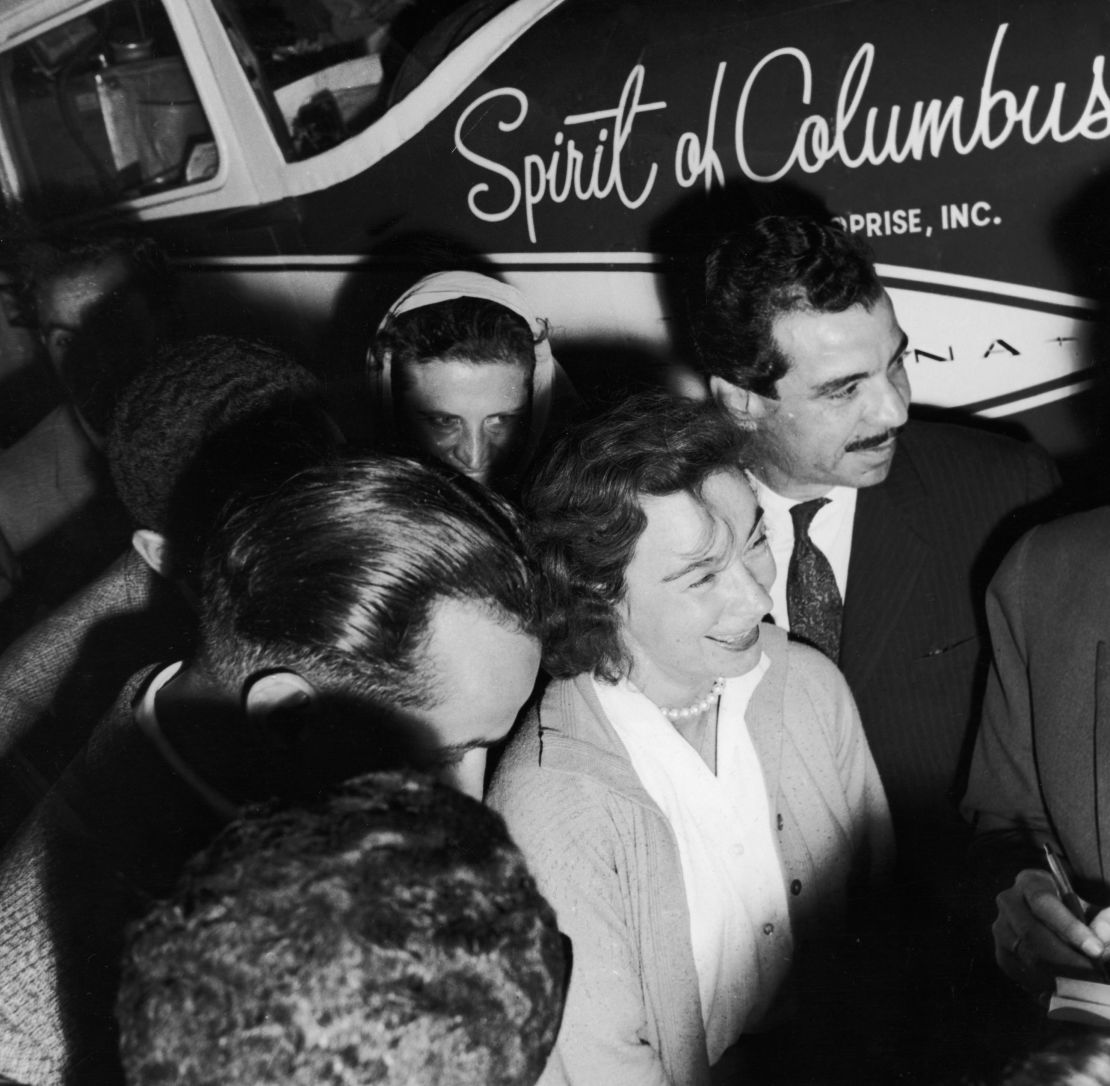 Mock, surrounded by reporters upon her arrival in Egypt.