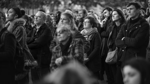 An overflow crowd celebrates Mass in the public square in front of the Church of Saint-Sulpice during Holy Week in Paris. The Mass was originally scheduled to be held in the Cathedral of Notre Dame.