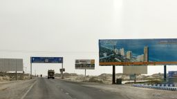 A billboard advertisement for a housing development stands along a highway on the outskirts of Gwadar, Balochistan, Pakistan, on Monday, July 3, 2018. What used to be a small fishing town on the southwestern corner of Pakistan is giving way for construction of roads and buildings to house banks, insurance and clearing agents. China Overseas Port Holdings, Gwadar Ports operator, has separately spent $250 million to add five new cranes, construct a building in less than six months by importing ready made parts and create space for a free zone. Photographer: Asim Hafeez/Bloomberg via Getty Images
