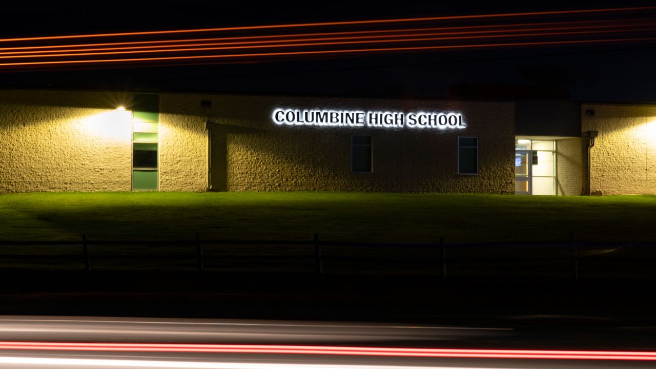 Lights streak as a truck drives by Columbine High School in Littleton, Colorado, in this long-exposure photograph.