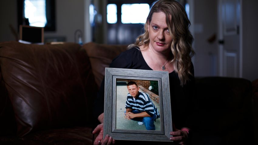 Jennifer Alba poses for a photograph with a picture of her son Joseph at her home in Apex, NC, Tuesday, March 26, 2019. Alba's oldest son Joseph Hockett battled addiction on and off for years, since his early teens. His mother can't pinpoint what caused his first forays into drug usage, but she said the change in him was obvious. Then, in August of 2017, Joseph received a massive insurance check for more than 30 thousand dollars. The giant sum of money put him over the edge and fueled a drug binge that ultimately ended his life, alone in a hotel room. Now, Jennifer wants her son's story told to try and prevent a similar situation happening again. (Eamon Queeney for CNN)