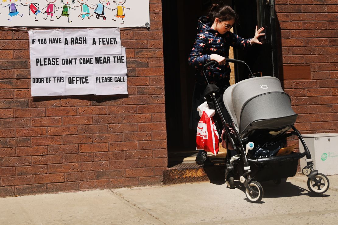 A sign warns residents of a measles outbreak in the Williamsburg neighborhood of Brooklyn.  